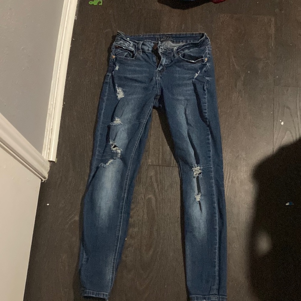 Mid-rise, dark blue jeans.